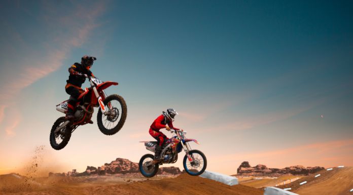 2 men on motocross jumping off their dirt bike