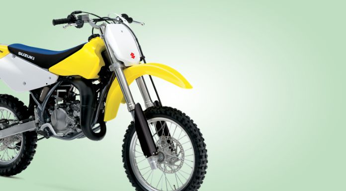 Isolated image of Suzuki dirt bike in light green background